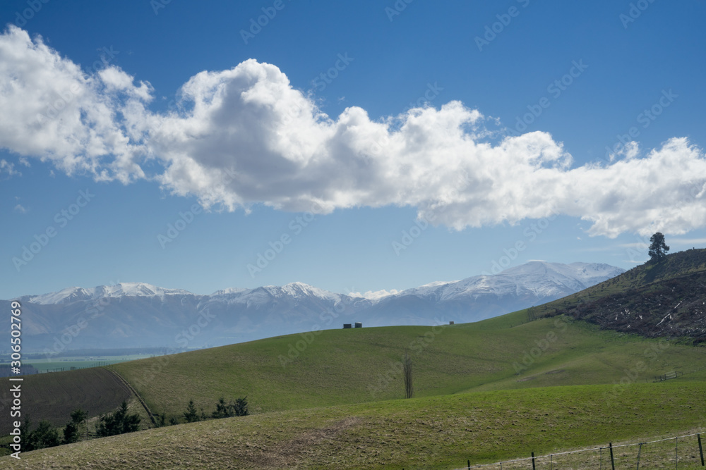 New Zealand scenic route with snowcap mountain in background.