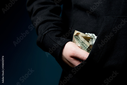 a female hand takes out or puts in her pocket several dirty crumpled dollar bills