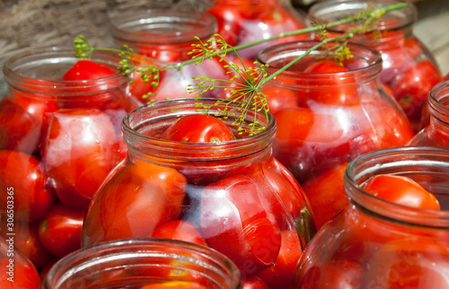 Pickling (canning) the tomatoes.