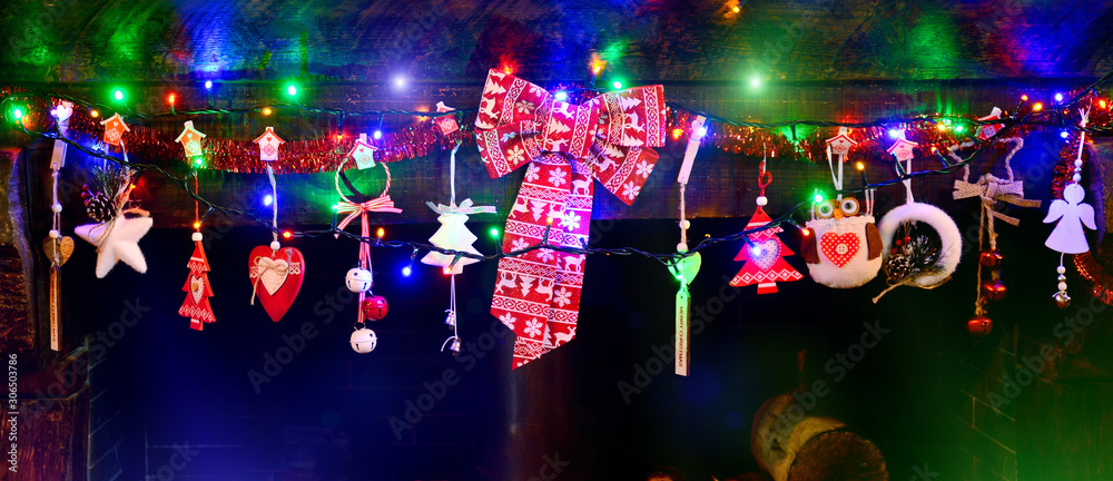 christmas decoration on the fireplace with colored lights