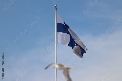 Flag of Finland blowing in the wind in Helsinki on holiday. Travelling with cruise ship in summer.