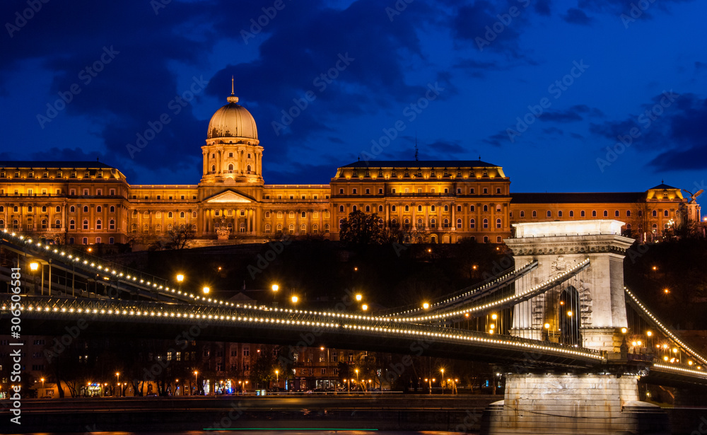 Royal Palace or the Buda Castle and the Chain Bridge after sunset in Budapest in Hungary.