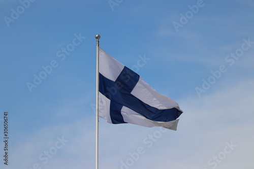 Flag of Finland blowing in the wind in Helsinki on holiday. Travelling with cruise ship in summer.