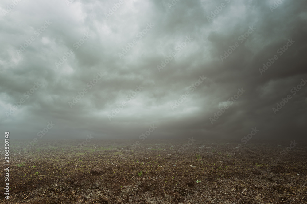Fototapeta premium Dark mood background with gravel grass mist and clouds 