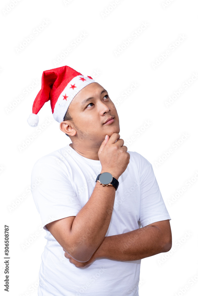 portrait of handsome casual asian man wear red santa hat raise his arm and touch his chin and look thinking portrait of handsome casual asian man wear red santa hat raise his arm and touch his chin and look thinking