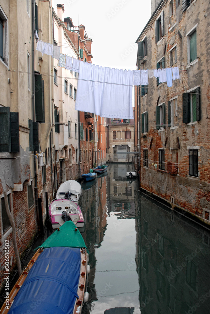  image of a venice canal with clothes hanging out drying