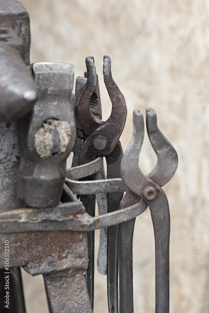 Pliers, tongs, hammer, anvil - blacksmith, metalsmith, farrier tools. Pliers, tongs, hammer, anvil - blacksmith, metalsmith, farrier tools.