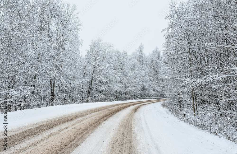 Road on a snowy December day in the countryside. Road on a snowy December day in the countryside.