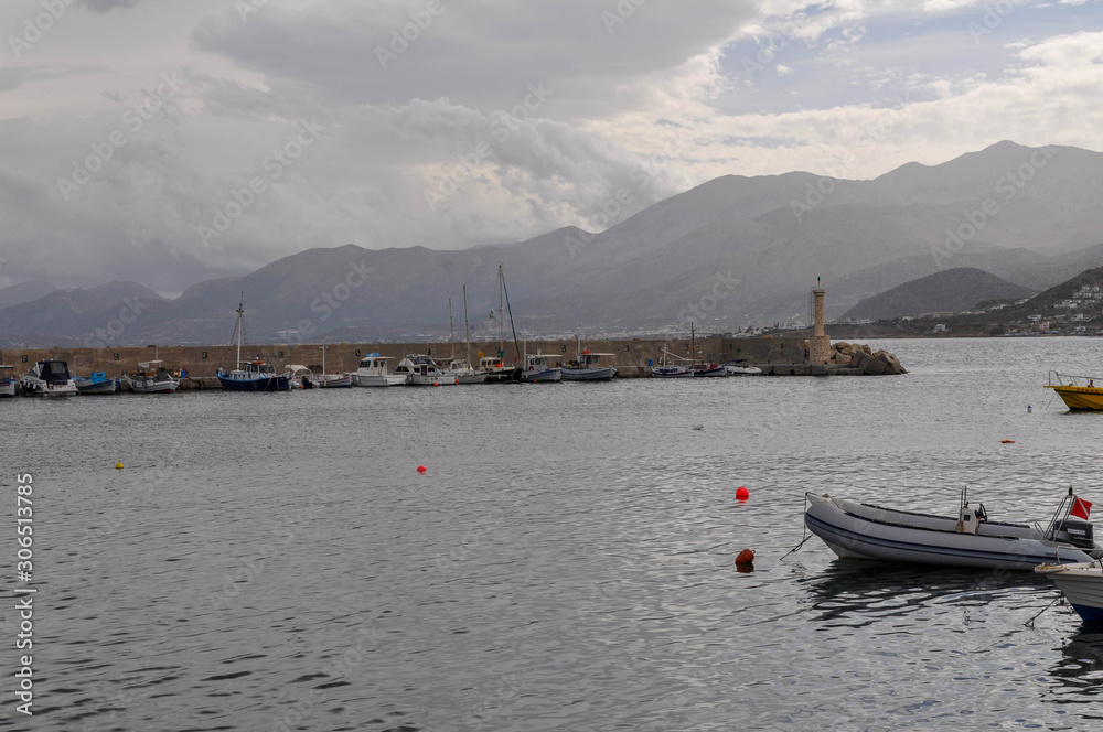 Pier with yachts of the island of Crete in Aegean sea Pier with yachts of the island of Crete in Aegean sea