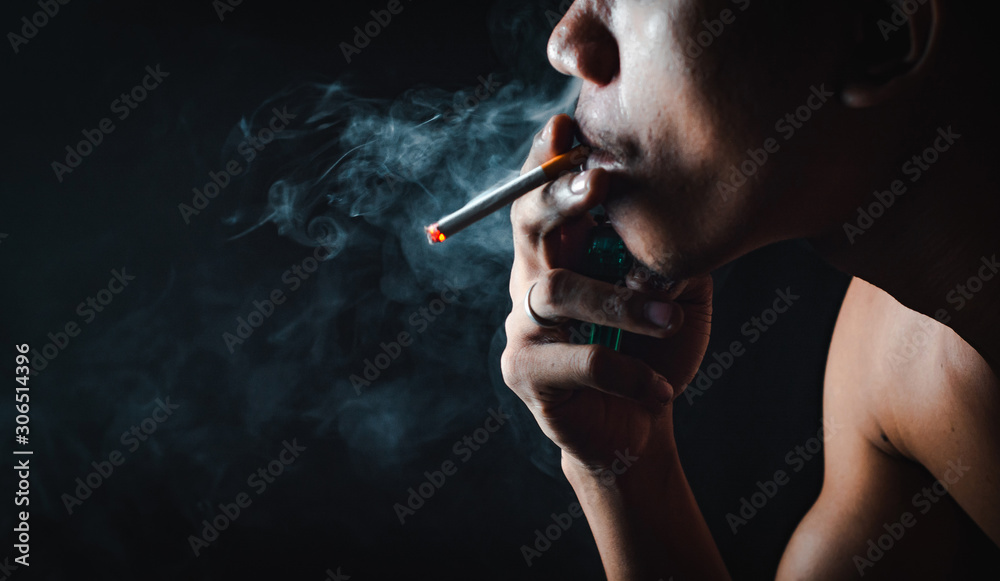 Fototapeta premium People who smoke with a black background Causing lung cancer 