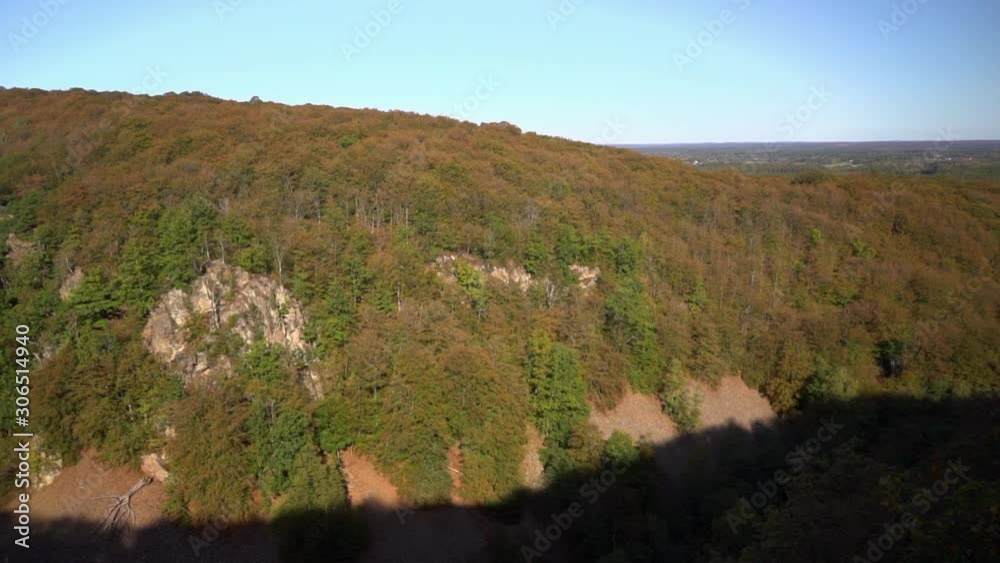 camera panning over a big valley in the nature with rubble stone and beech trees. it's a beautiful day with blue skies. camera panning over a big valley in the nature with rubble stone and beech trees. it's a beautiful day with blue skies.