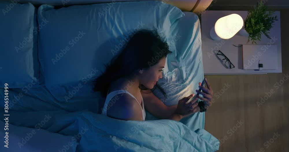 woman use smartphone on bed