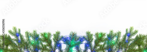 Christmas and New year holiday banner; Fir branches and christmas lights on the white background. Copy space, flat lay