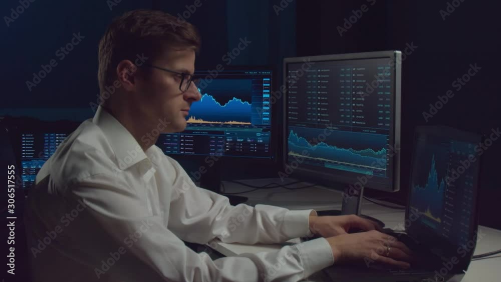 Broker working in office using workstation and analysis technology. Workplace of professional trader. Global financial markets, business strategy, currency exchange and banking. Broker working in office using workstation and analysis technology. Workplace of professional trader. Global financial markets, business strategy, currency exchange and banking.