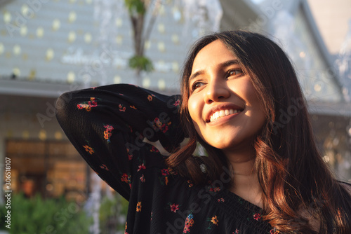 Asian ethnicity diverse woman smiling and enjoying afternoon sunshine outdoors - Headshot of carefree trendy lifestyle millennial girl shopping downtown - Summer, hipster and weekend leisure concept