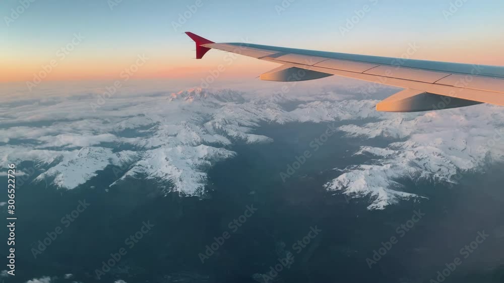Flying over the Alps. View from the airplane porthole to the top of Mont Blanc Flying over the Alps. View from the airplane porthole to the top of Mont Blanc