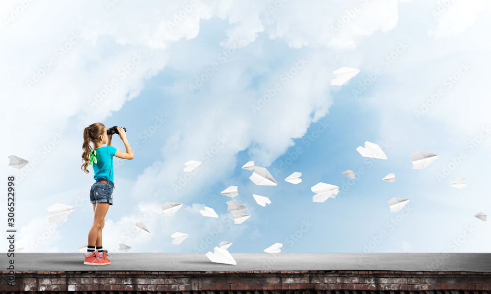 Concept of careless happy childhood with girl of school age looking in future Concept of careless happy childhood with girl of school age looking in future
