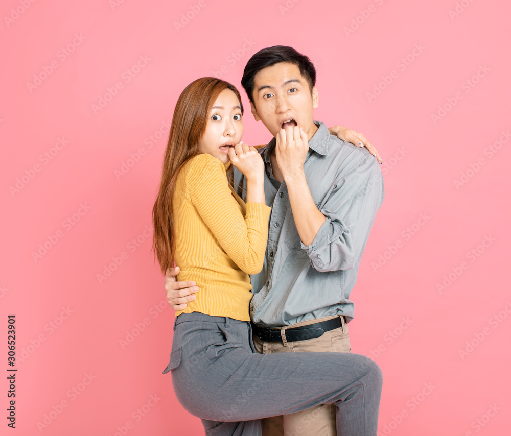 Shocked and surprised young couple holding together Shocked and surprised young couple holding together