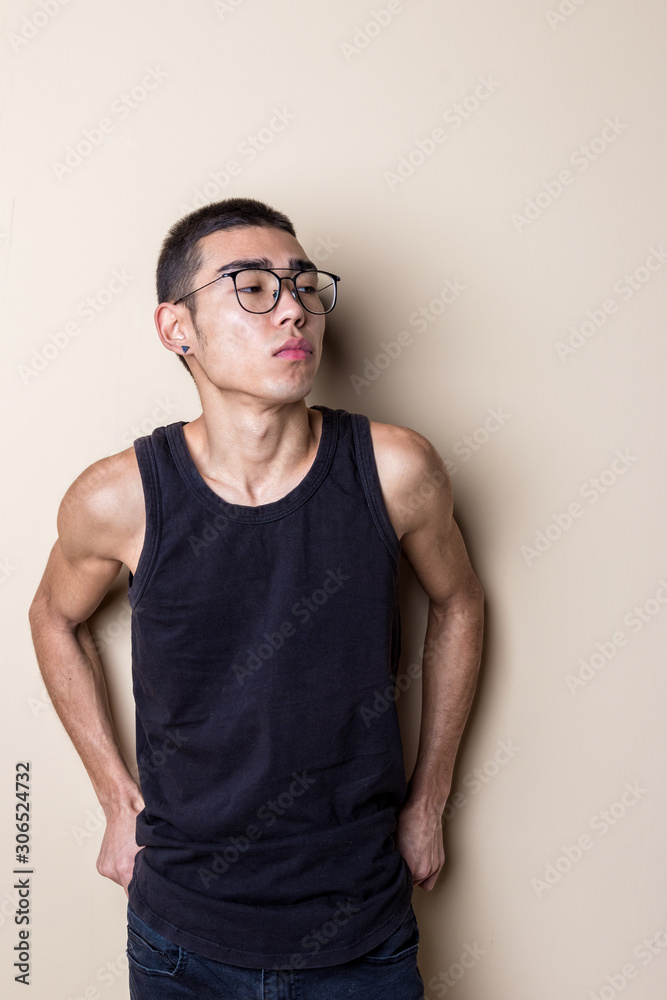 Young sexy man in glasses posing and looking at camera Young sexy man in glasses posing and looking at camera