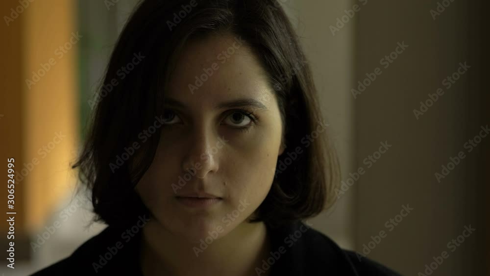 thoufghtful serious pretty young woman looking at acmera in the dark- outdoor thoufghtful serious pretty young woman looking at acmera in the dark- outdoor