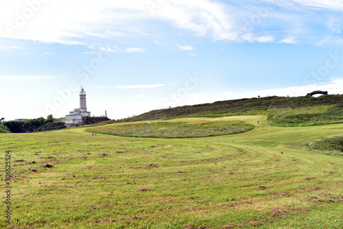 Cabo Mayor Park on a sunny day and Lighthouse of Cabo Mayor at the background, Santander, Cantabria, Spain © akturer