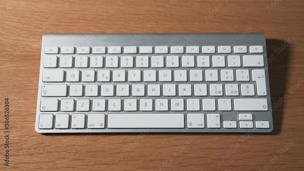 Left hand pressing brightness down and up on a keyboard Left hand pressing brightness down and up on a keyboard