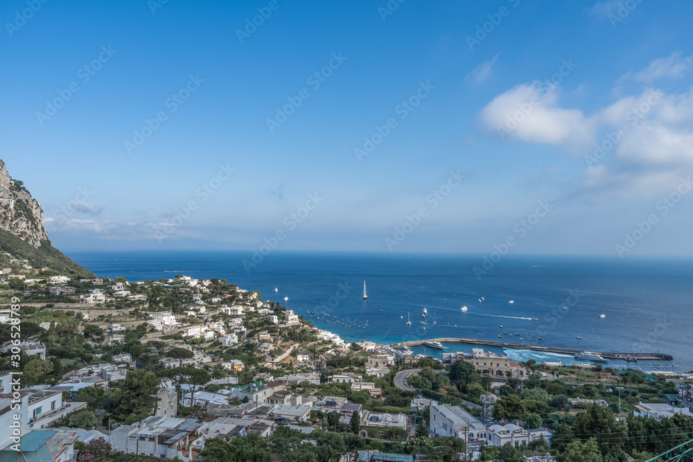 Capri city on Capri Island with Tyrrhenian sea with boats in summer time
