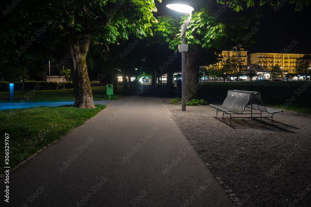 Empty gravel walk path with fresh green trees at night time for background with copy space