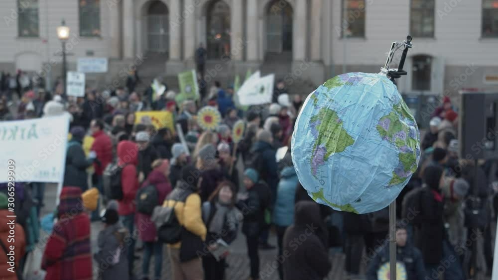 A blow-up globe being held at a climate protest.