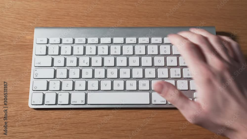 Right hand pressing play and volume buttons on a keyboard Right hand pressing play and volume buttons on a keyboard