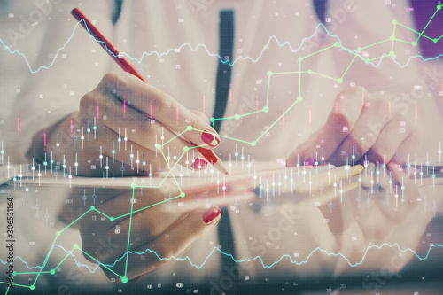 Wallpaper Mural A woman hands writing information about stock market in notepad. Forex chart holograms in front. Concept of research. Torontodigital.ca