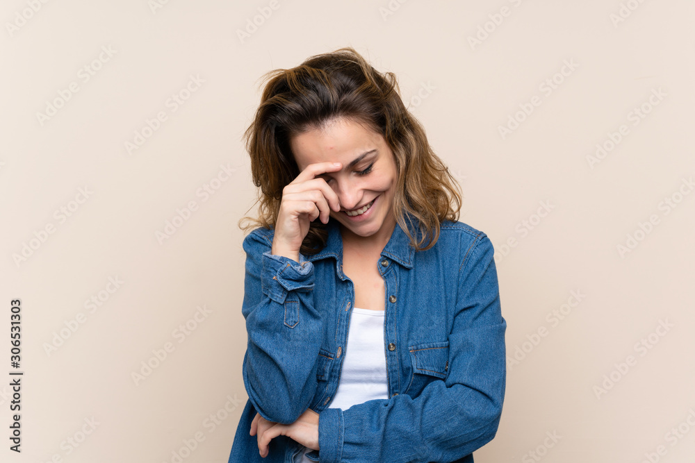 Young blonde woman over isolated background laughing Young blonde woman over isolated background laughing