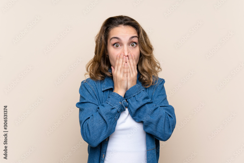 Young blonde woman over isolated background with surprise facial expression Young blonde woman over isolated background with surprise facial expression