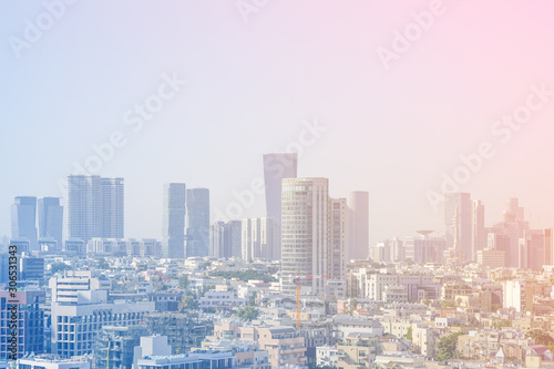Cityscape, modern building on a blue background. City blurred lights background after sunset. Morning view of the business center of Tel Aviv, Israel. Modern city. 