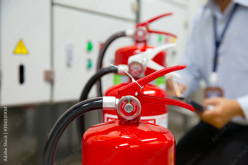 Engineer are inspection Fire extinguisher in fire control room for emergency, rescue and safety Concept.