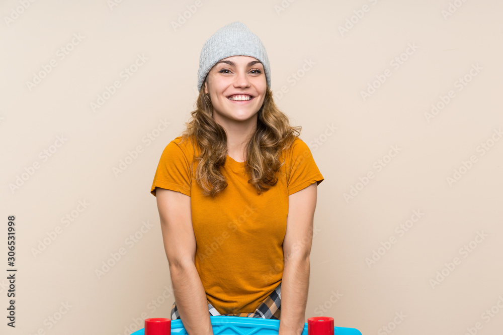 Young skater blonde girl over isolated background Young skater blonde girl over isolated background