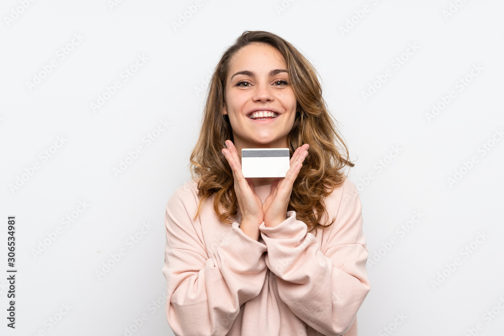 Young blonde woman holding a credit card Young blonde woman holding a credit card
