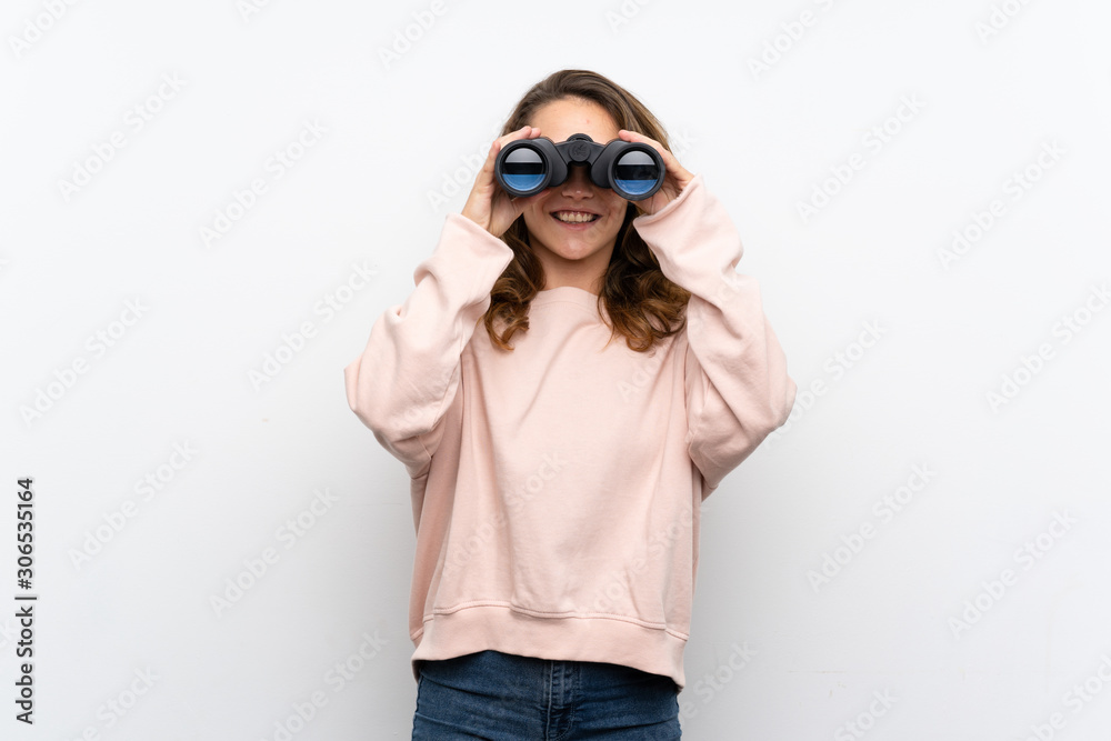 Young blonde woman with black binoculars Young blonde woman with black binoculars