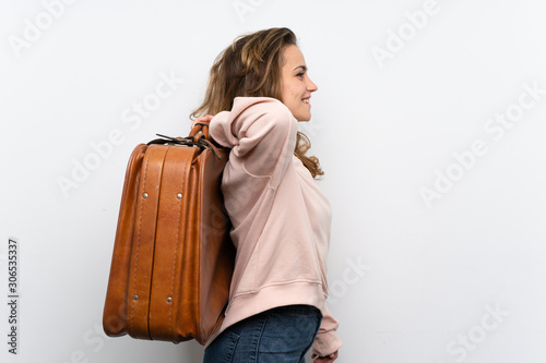 Young blonde woman holding a vintage briefcase