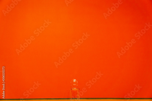 Transparent chair on a red background.