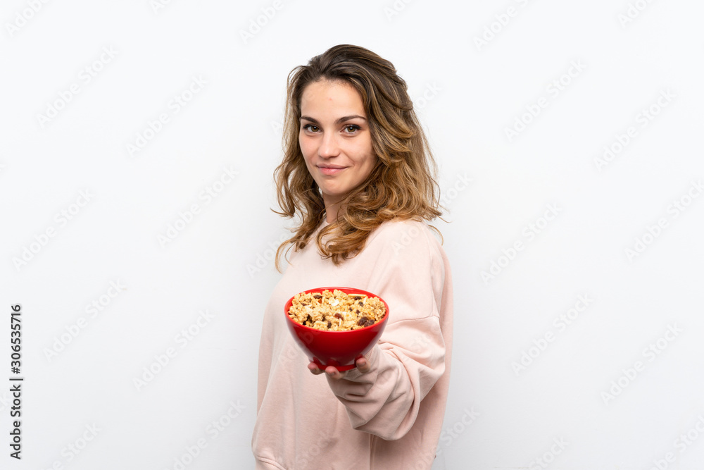 Young blonde woman holding a bowl of cereals Young blonde woman holding a bowl of cereals