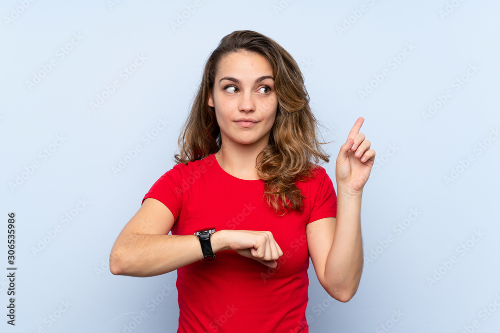 Young blonde woman looking at the hand watch Young blonde woman looking at the hand watch