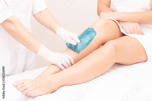 azulene depilation. wax hair removal, shugaring. concept of smooth skin without hair. azulene of green color. removal of azulene from the skin
