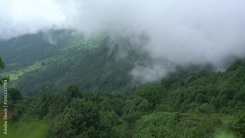 Day timelapse of fog movement over a hill with the sun rays shining in the background. Wide Shot. Day timelapse of fog movement over a hill with the sun rays shining in the background. Wide Shot.