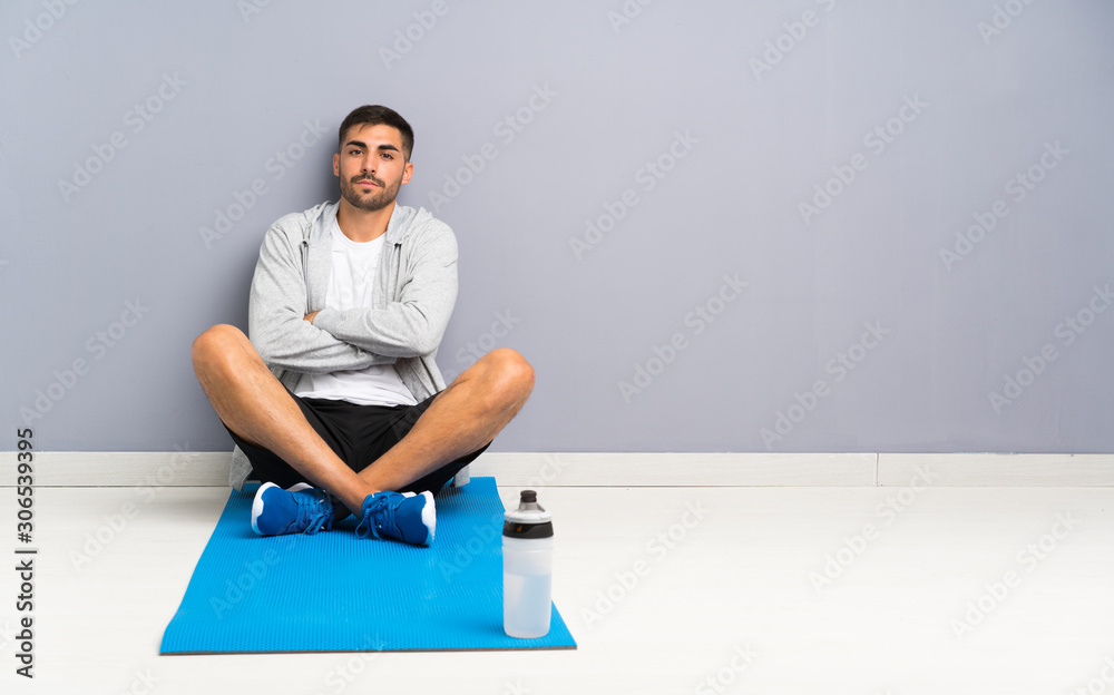 Sport man sitting one the floor keeping arms crossed Stock Photo ...