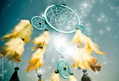 blue dreamcatcher with white feathers and stars  photo