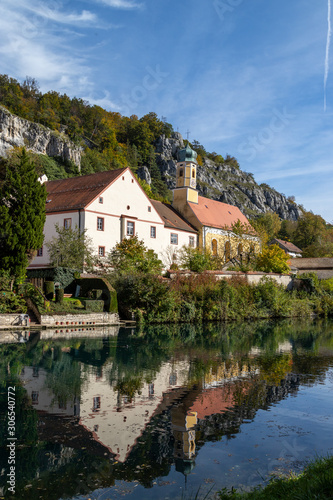 Idyllic view at the village Markt Essing in Bavaria, Germany with the Altmuehl river and high rocks