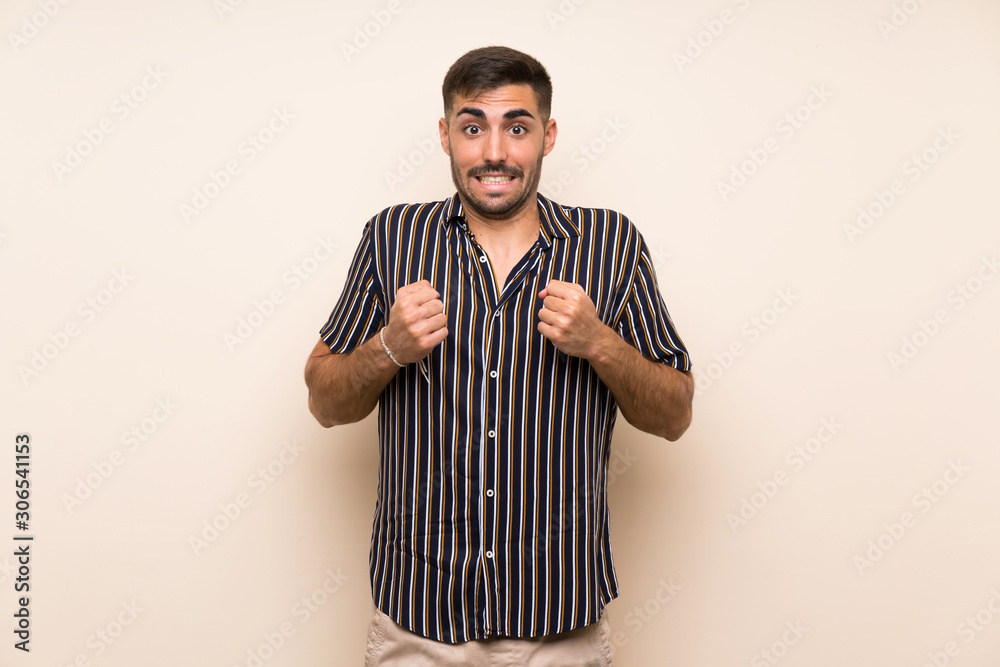 Fototapeta premium Handsome man with beard over isolated background celebrating a victory