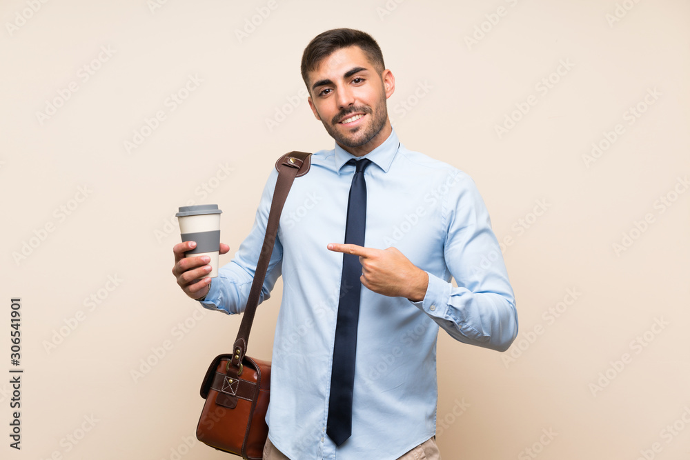 Young business with beard holding a take away coffee Young business with beard holding a take away coffee