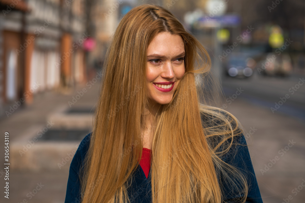 Young beautiful blonde woman in a blue coat Young beautiful blonde woman in a blue coat